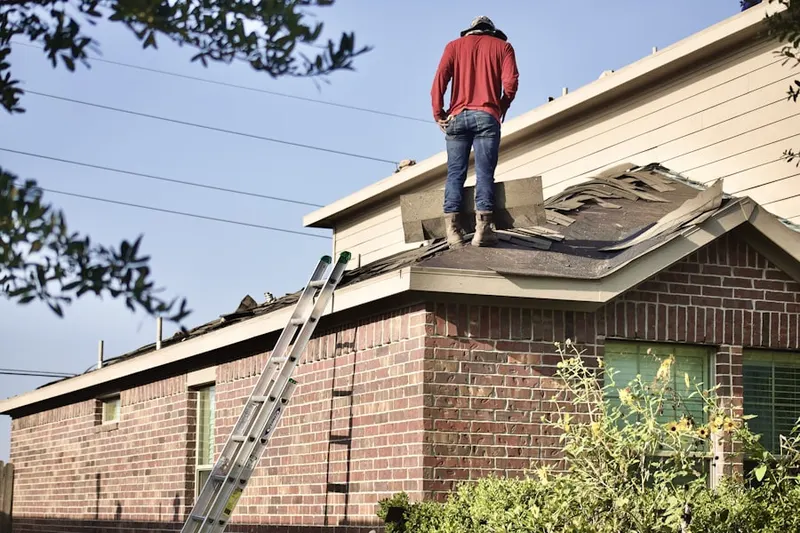 Professional roofer working on a residential roof in Calimesa